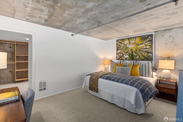 a spacious bedroom with a bed and glass windows