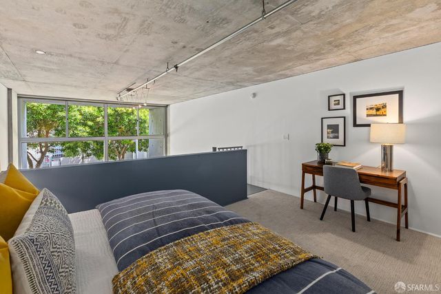 a bedroom with furniture and a window