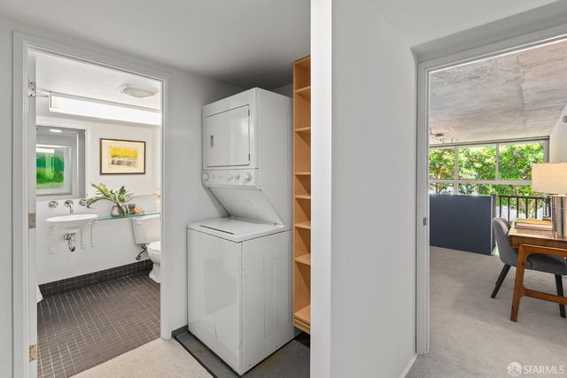 a room with a chair and a washer dryer