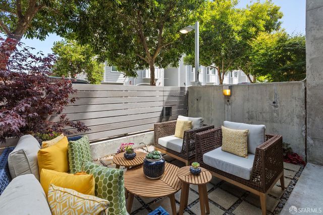 a view of a chairs and table in the back yard of the house