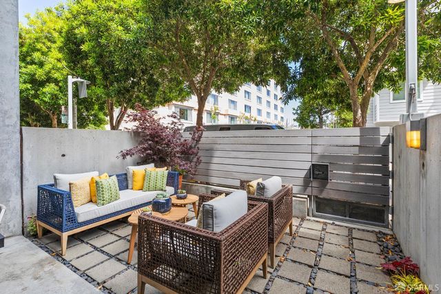 a view of a patio with a table and chairs
