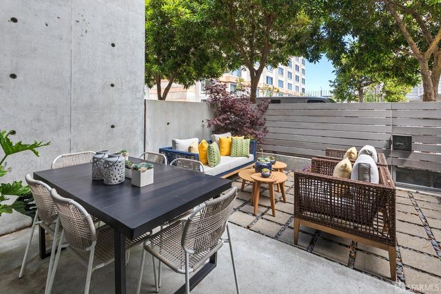 a view of a house with backyard and sitting area