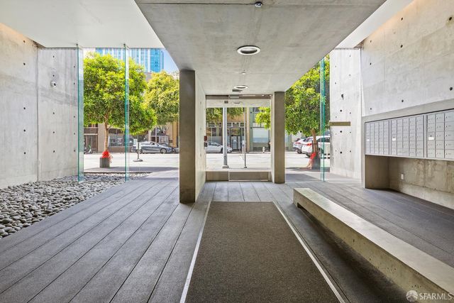 a view of a patio with wooden floor and iron stairs