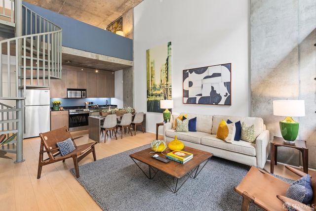 a living room with furniture and kitchen view