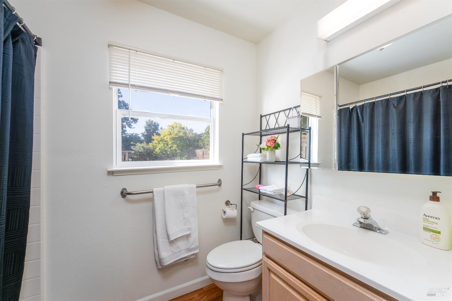 92 Oak Knoll Road Ukiah, CA 95482 - Photo 11 of 29 a bathroom with a toilet sink vanity shower and mirror