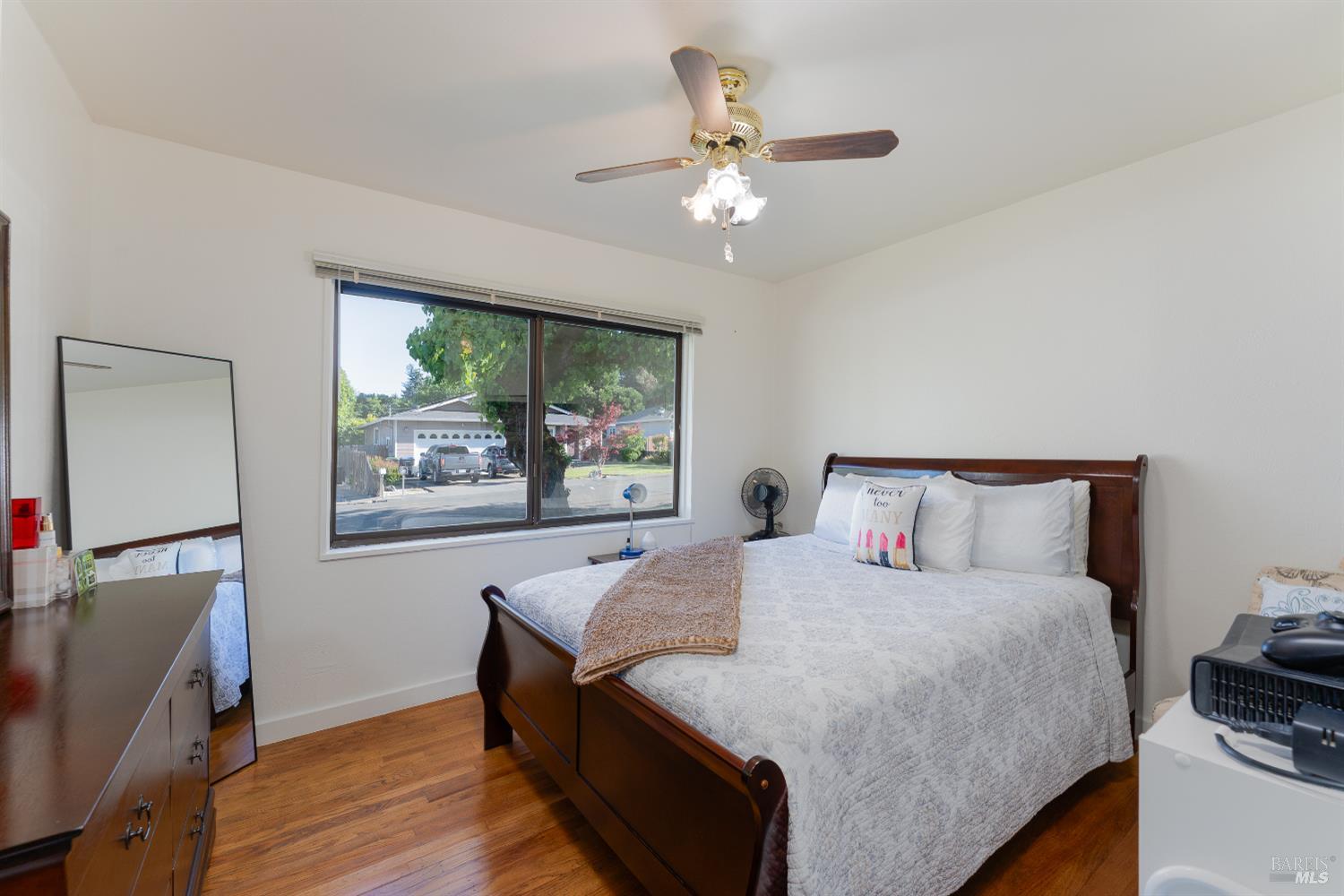 92 Oak Knoll Road Ukiah, CA 95482 - Photo 14 of 29 a bedroom with a bed and a chandelier