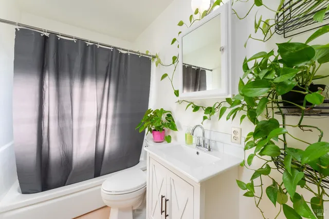 a bathroom with a sink a toilet and mirror