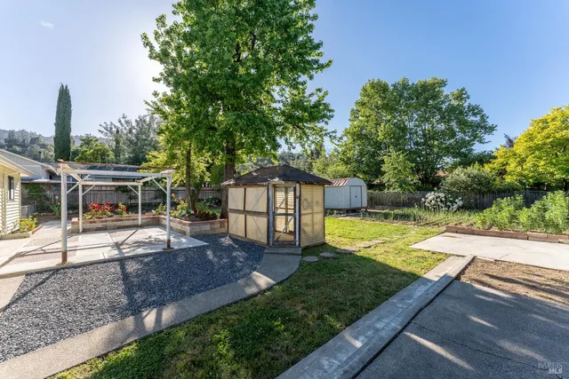 a view of a house with backyard and sitting area