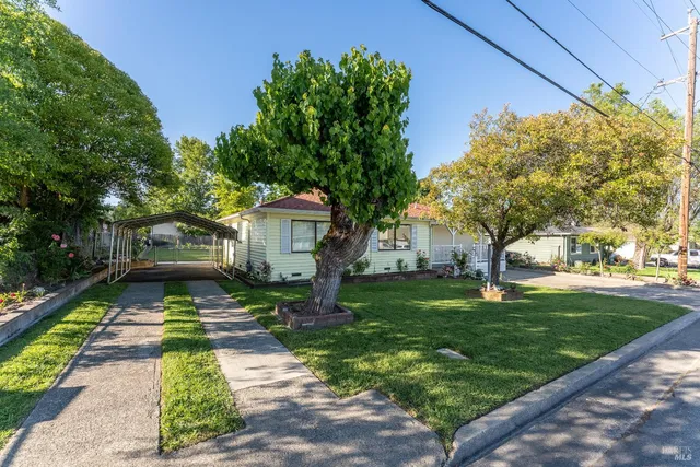a front view of a house with garden