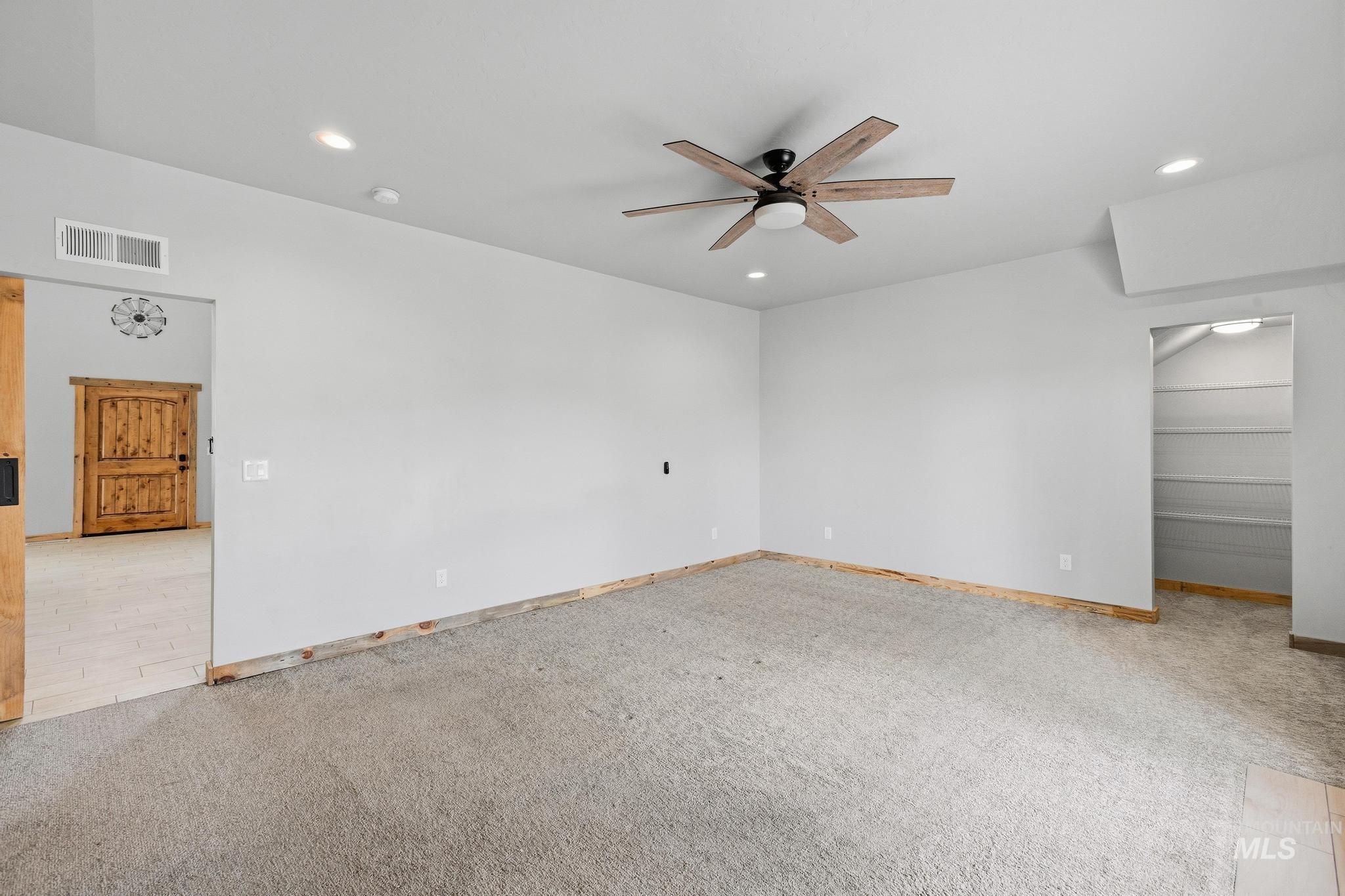870 Desert Wind Road Boise, ID 83716 - Photo 18 of 50 Spacious interior featuring a wood-finish ceiling fan, recessed lighting, and a prominent wood barn door