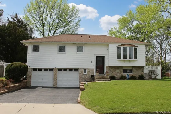 a front view of a house with a yard garage and outdoor seating