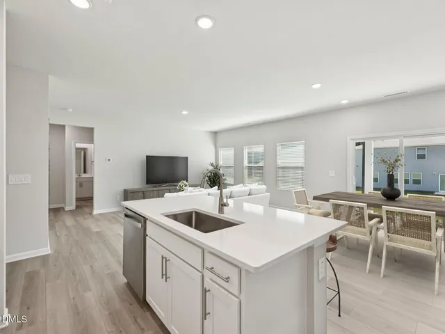 a living room with furniture and kitchen view
