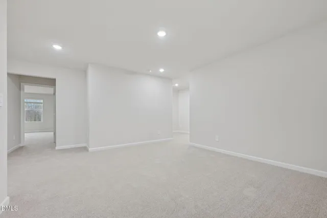 an empty room with a empty space and windows