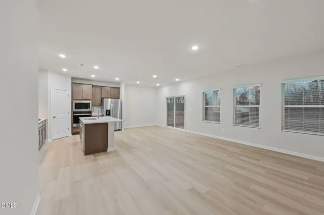 a large kitchen with stainless steel appliances granite countertop a stove and a refrigerator