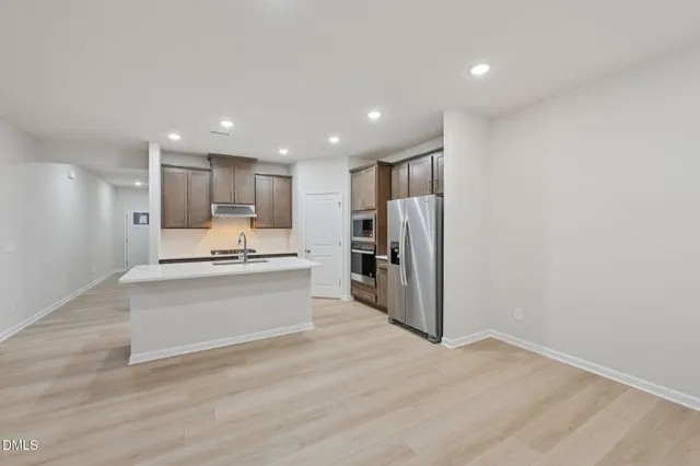 a view of kitchen with kitchen island microwave and stove