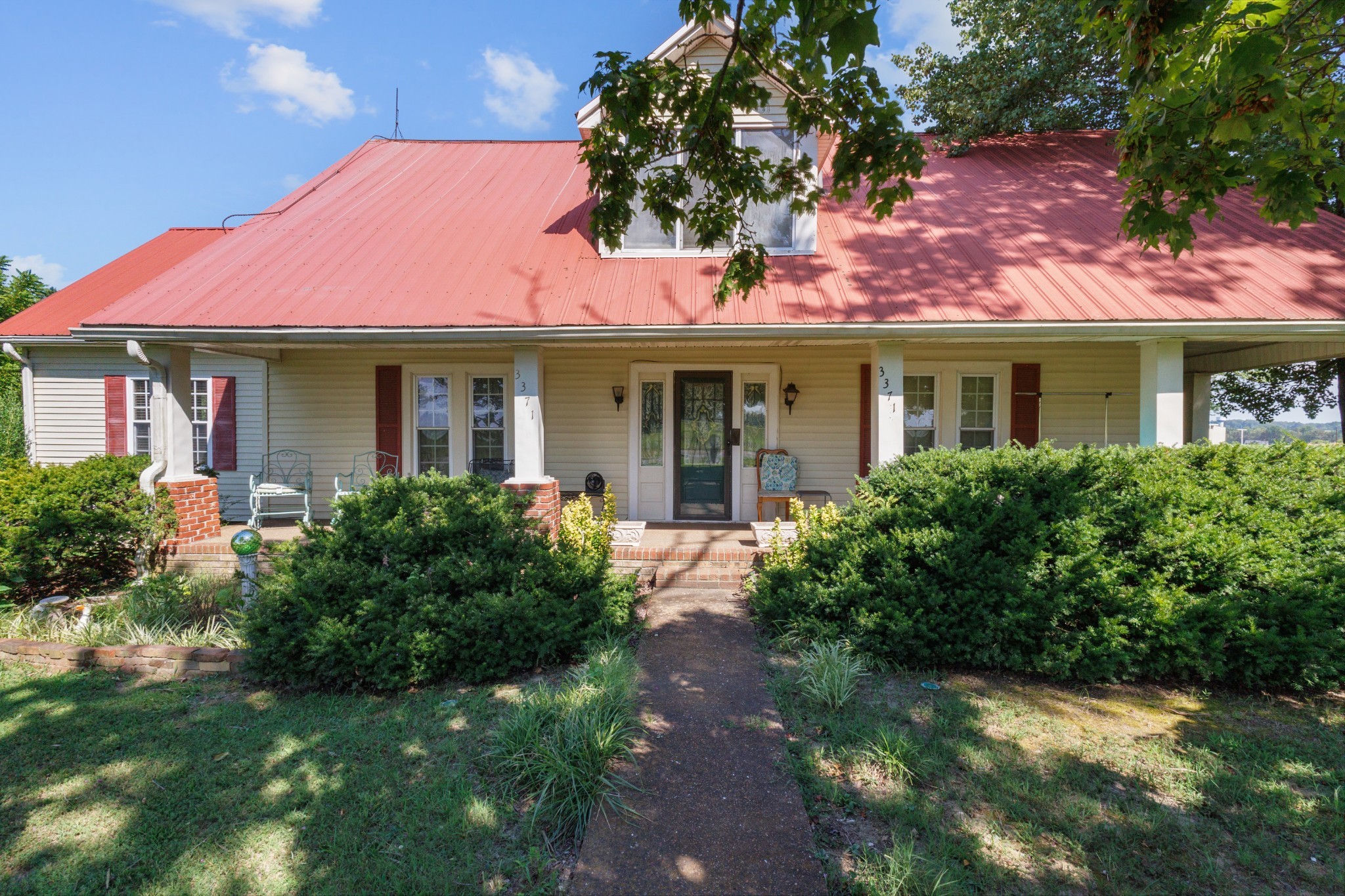3371 Highway 76 Cottontown, TN 37048 - Photo 1 of 54 a front view of a house with yard and green space