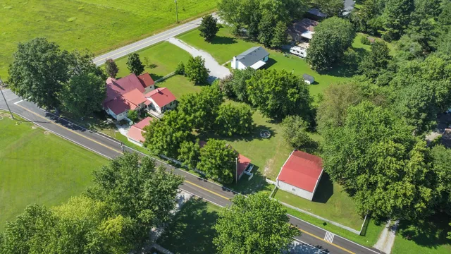 an aerial view of a house with a yard and lake view