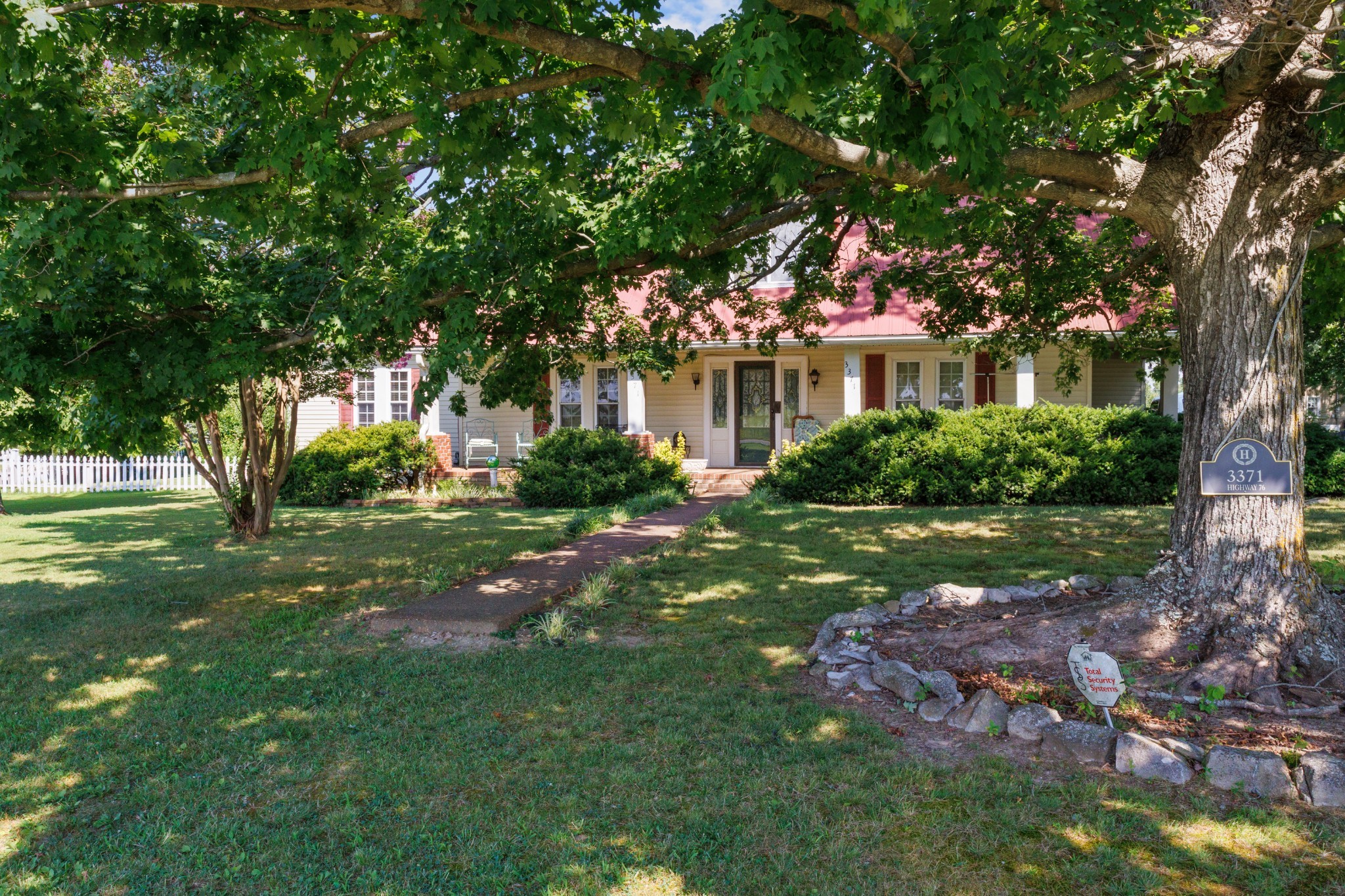 3371 Highway 76 Cottontown, TN 37048 - Photo 47 of 54 a front view of a house with a garden