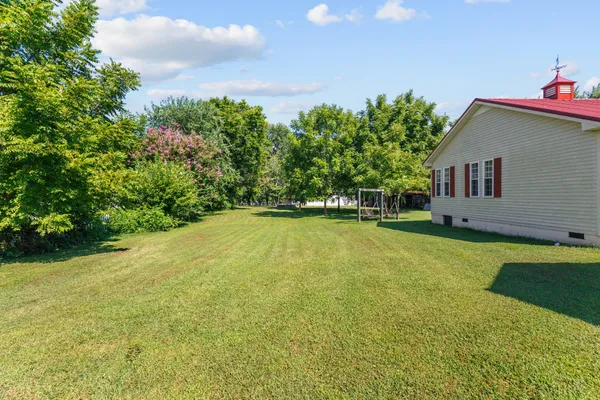 a view of a house with a backyard