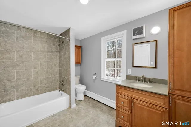 a bathroom with a bathtub sink and toilet
