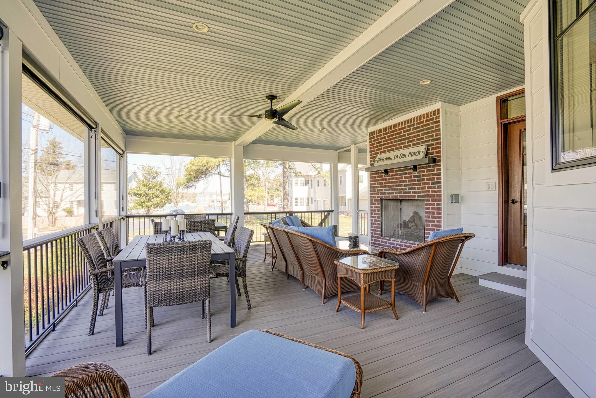303 Manor Street St. Michaels, MD 21663 - Photo 11 of 100 a dining room with furniture large windows and wooden floor