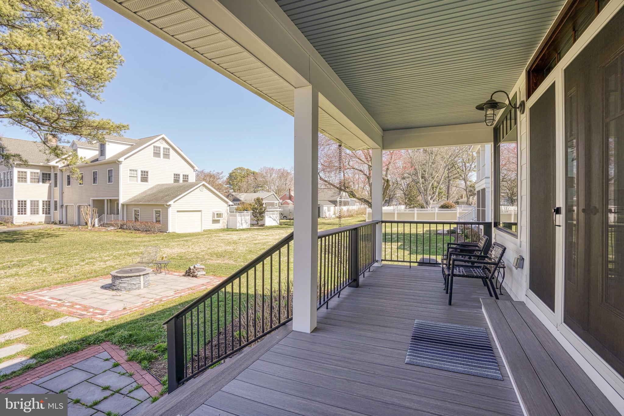 303 Manor Street St. Michaels, MD 21663 - Photo 17 of 100 a view of a balcony with wooden floor and iron fence