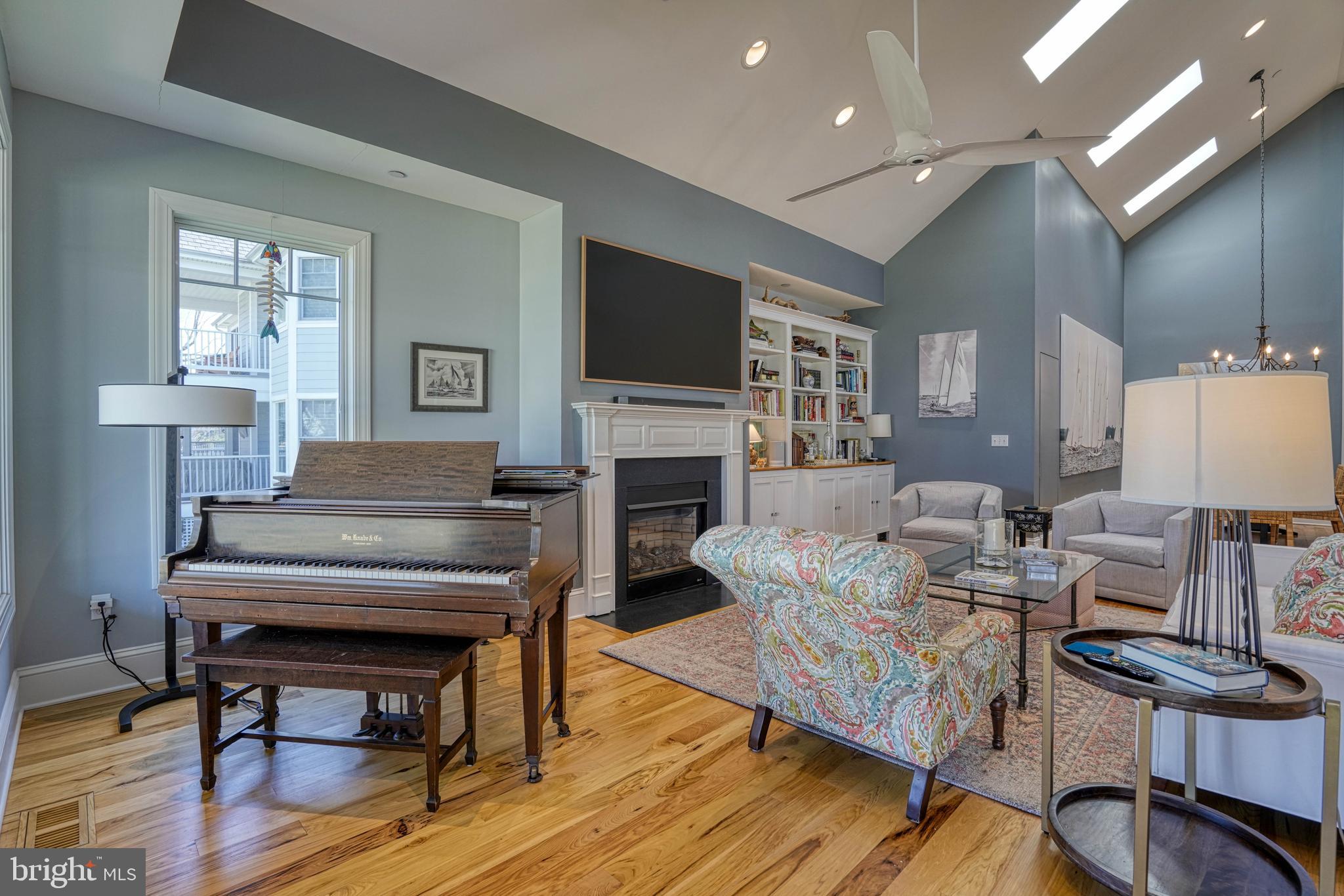 303 Manor Street St. Michaels, MD 21663 - Photo 23 of 100 a living room with furniture a fireplace and a flat screen tv