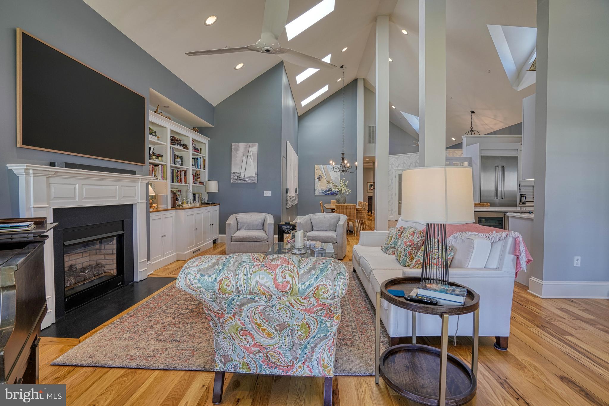 303 Manor Street St. Michaels, MD 21663 - Photo 24 of 100 a living room with furniture a flat screen tv and a fireplace