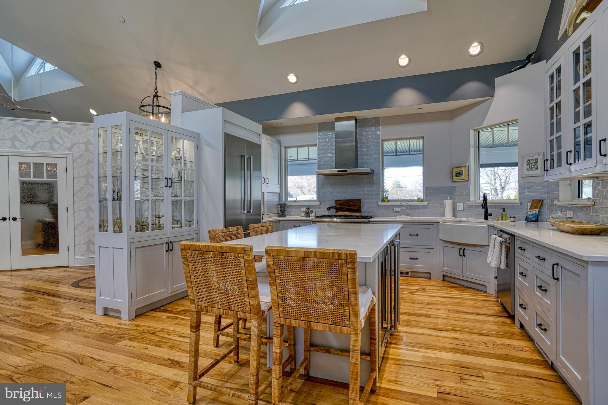 303 Manor Street St. Michaels, MD 21663 - Photo 33 of 100 a kitchen with stainless steel appliances granite countertop wooden cabinets a sink a stove a dining table and chairs