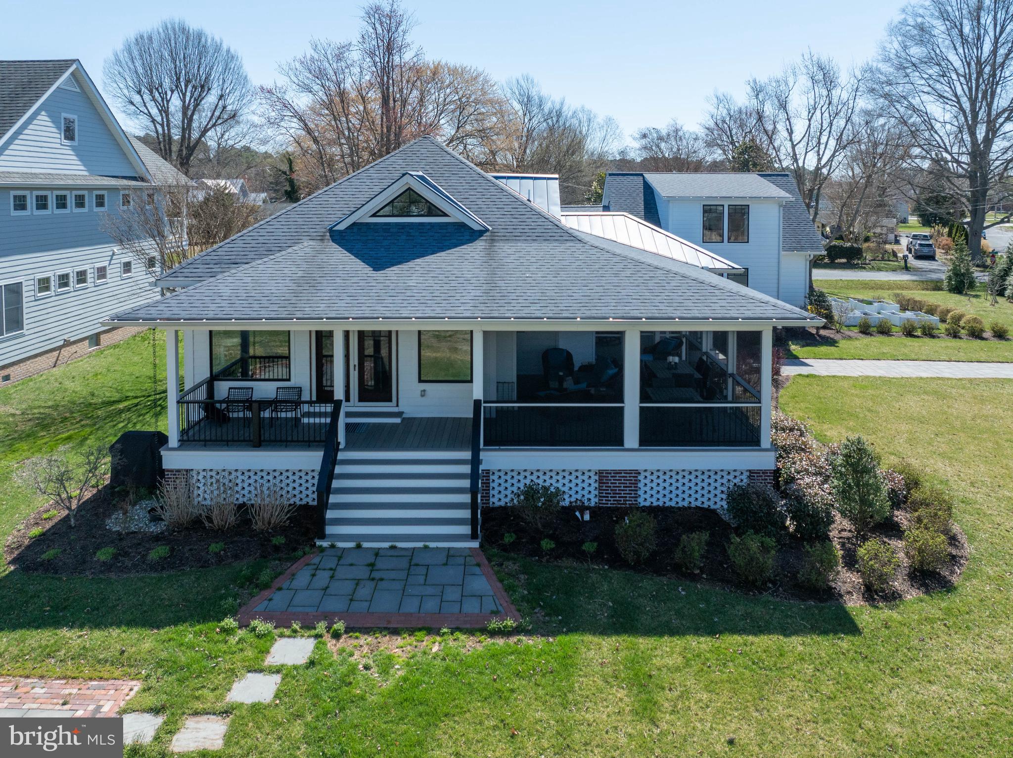 303 Manor Street St. Michaels, MD 21663 - Photo 5 of 100 a front view of a house with a yard