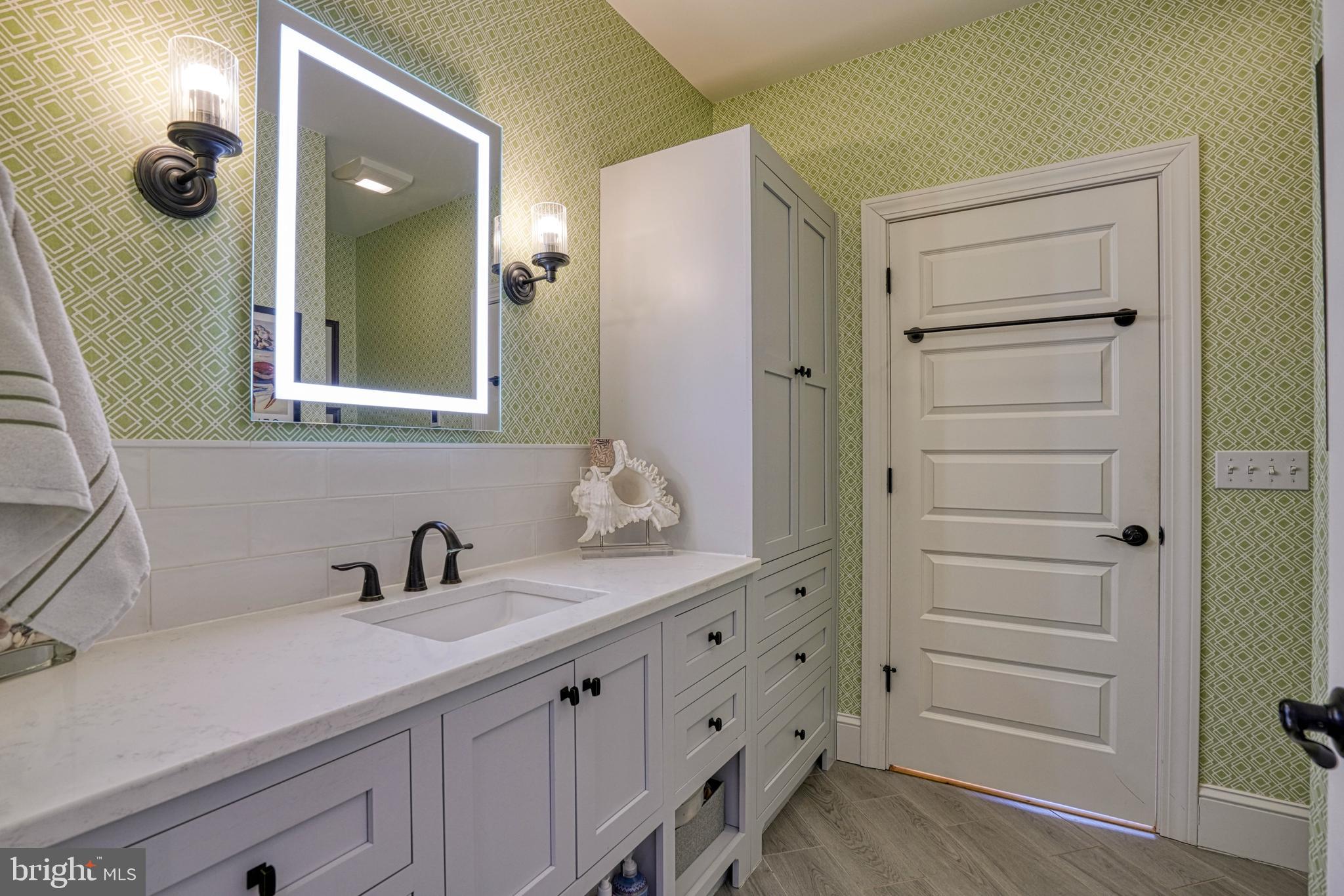 303 Manor Street St. Michaels, MD 21663 - Photo 63 of 100 a bathroom with a sink vanity and mirror