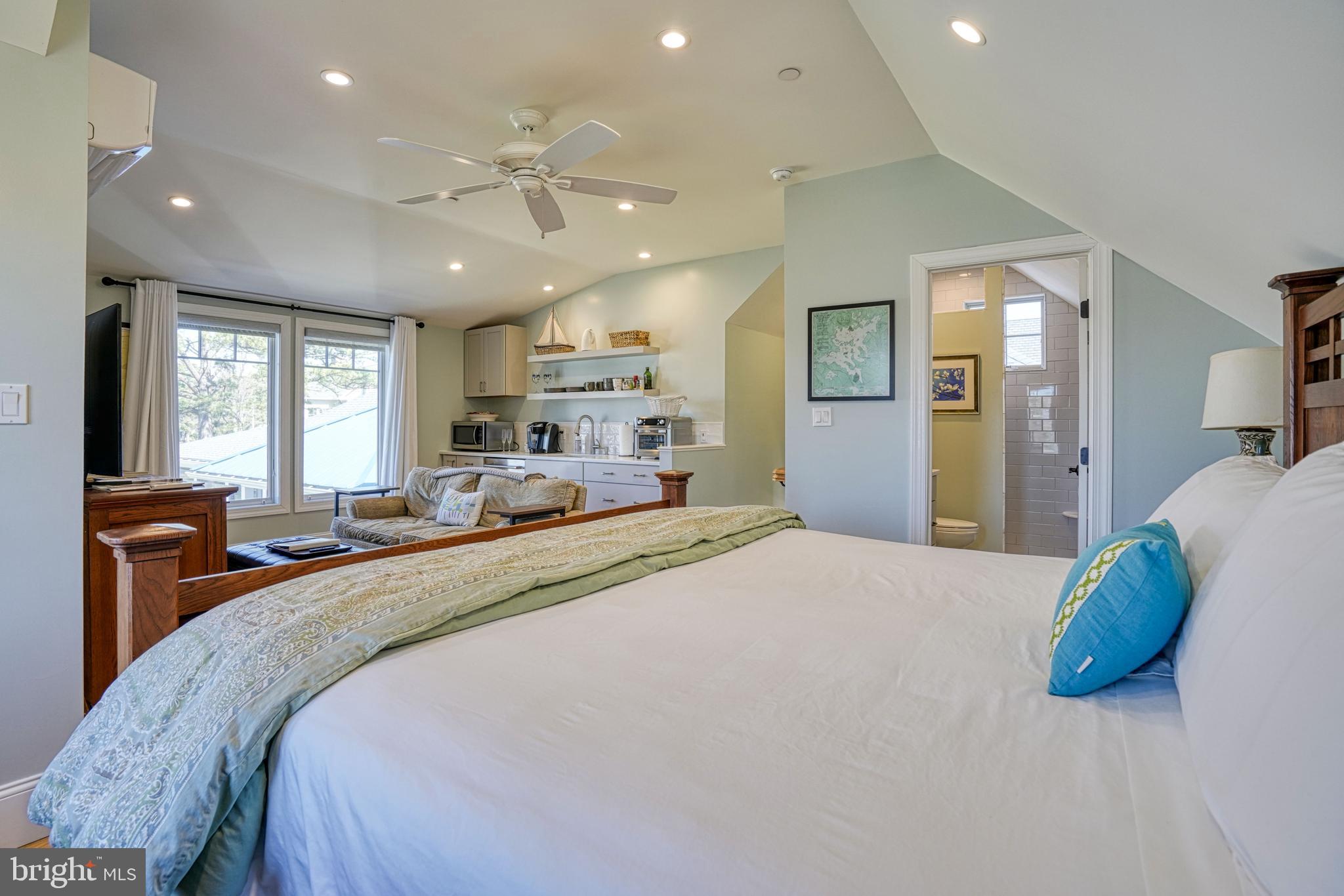 303 Manor Street St. Michaels, MD 21663 - Photo 73 of 100 a spacious bedroom with a large bed and a large mirror