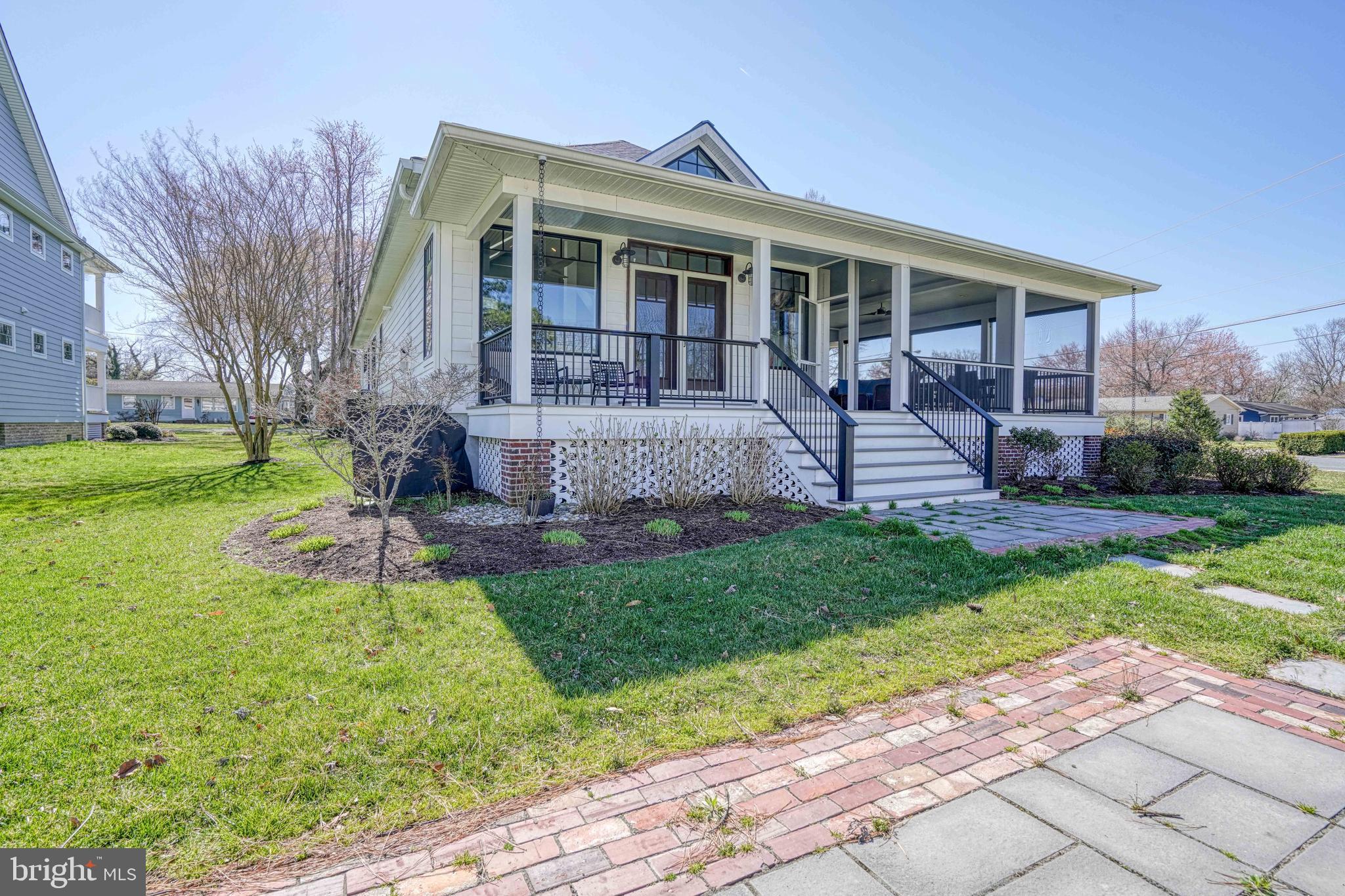 303 Manor Street St. Michaels, MD 21663 - Photo 85 of 100 a front view of a house with a yard and outdoor seating