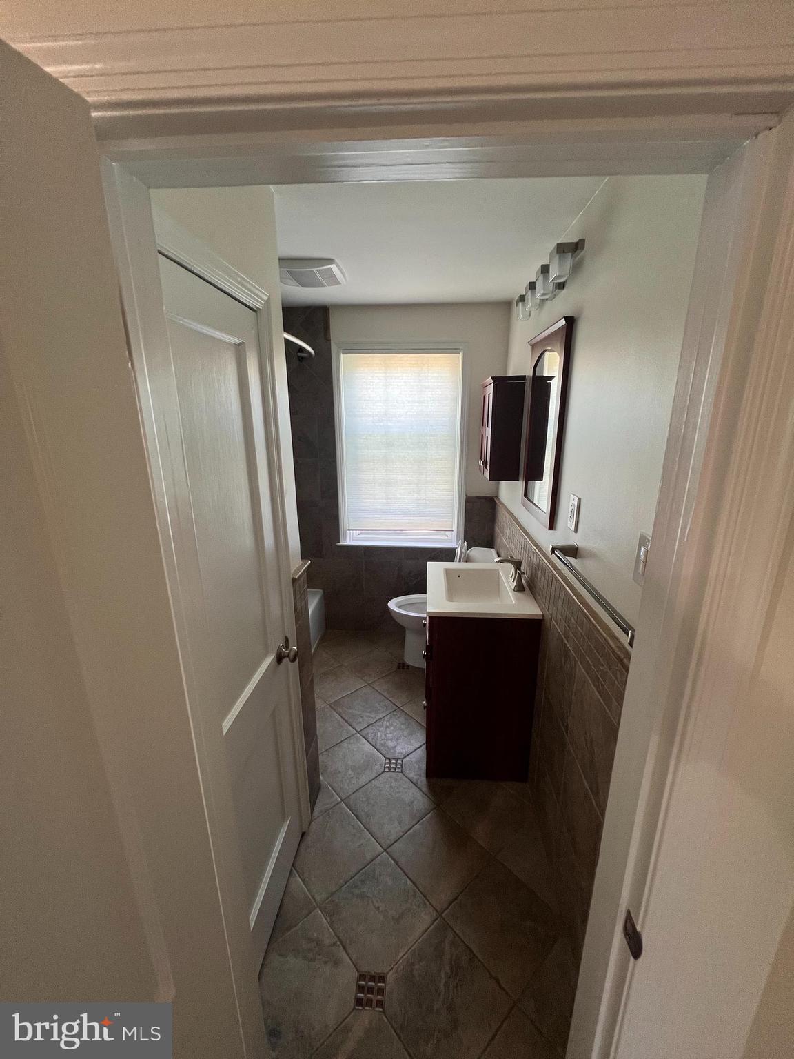 1583 Doxbury Road Towson, MD 21286 - Photo 16 of 31 a bathroom with a sink a mirror and a bathtub