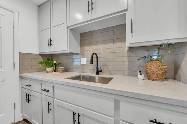 a kitchen with sink and cabinets