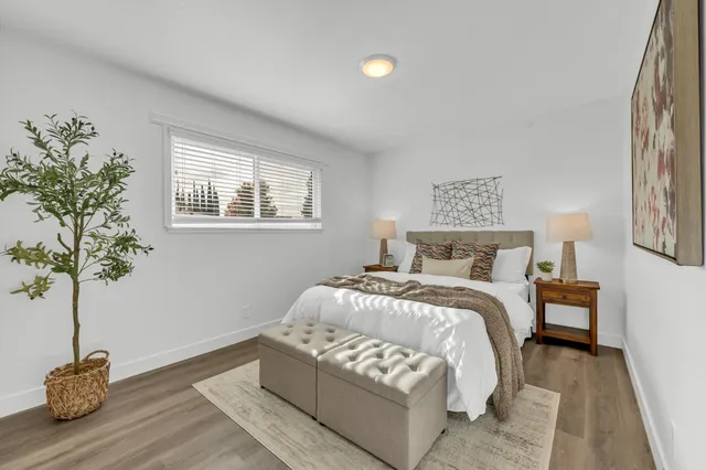 a bedroom with bed and a potted plant