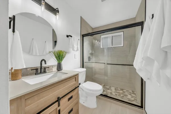 a bathroom with a sink toilet and shower