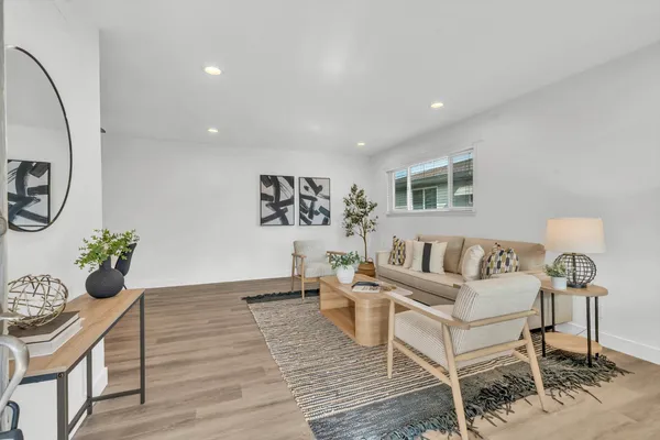 a living room with furniture and wooden floor