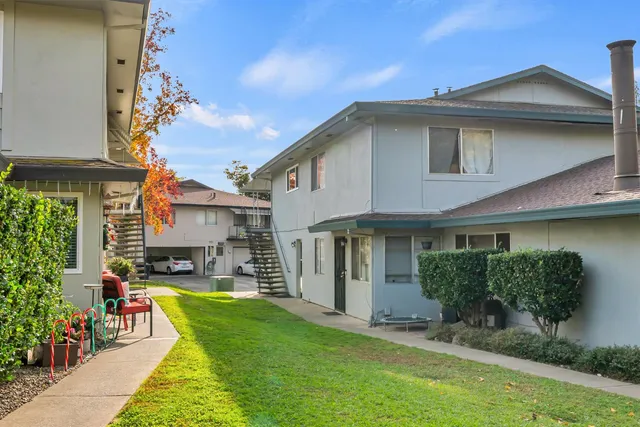 a view of a house with sitting area and garden