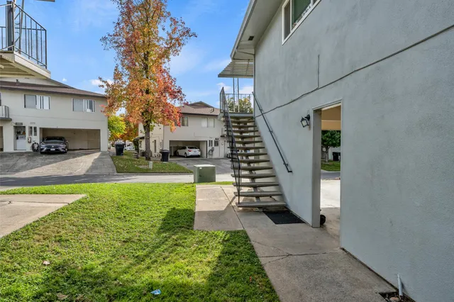 a porch with yard in front of it