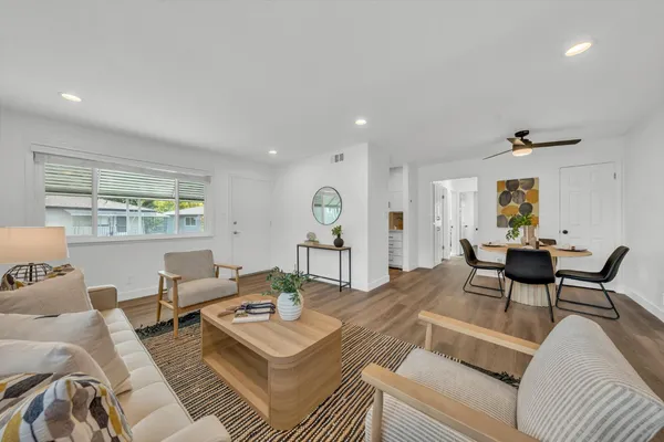 a living room with furniture and wooden floor