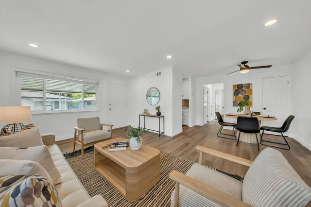 a living room with furniture and wooden floor