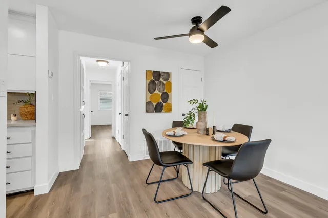 a dining room with furniture and wooden floor