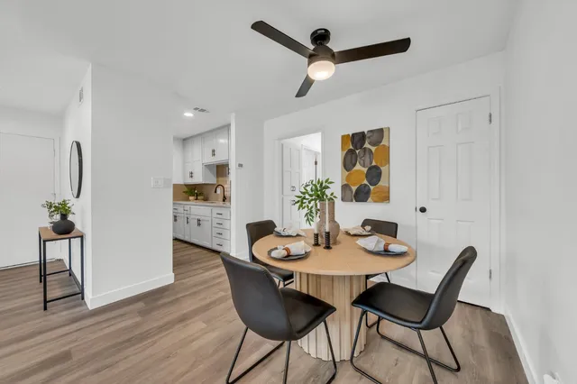 a view of a dining room with furniture and wooden floor