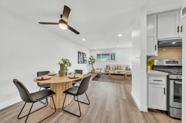 a view of a dining room with furniture and wooden floor