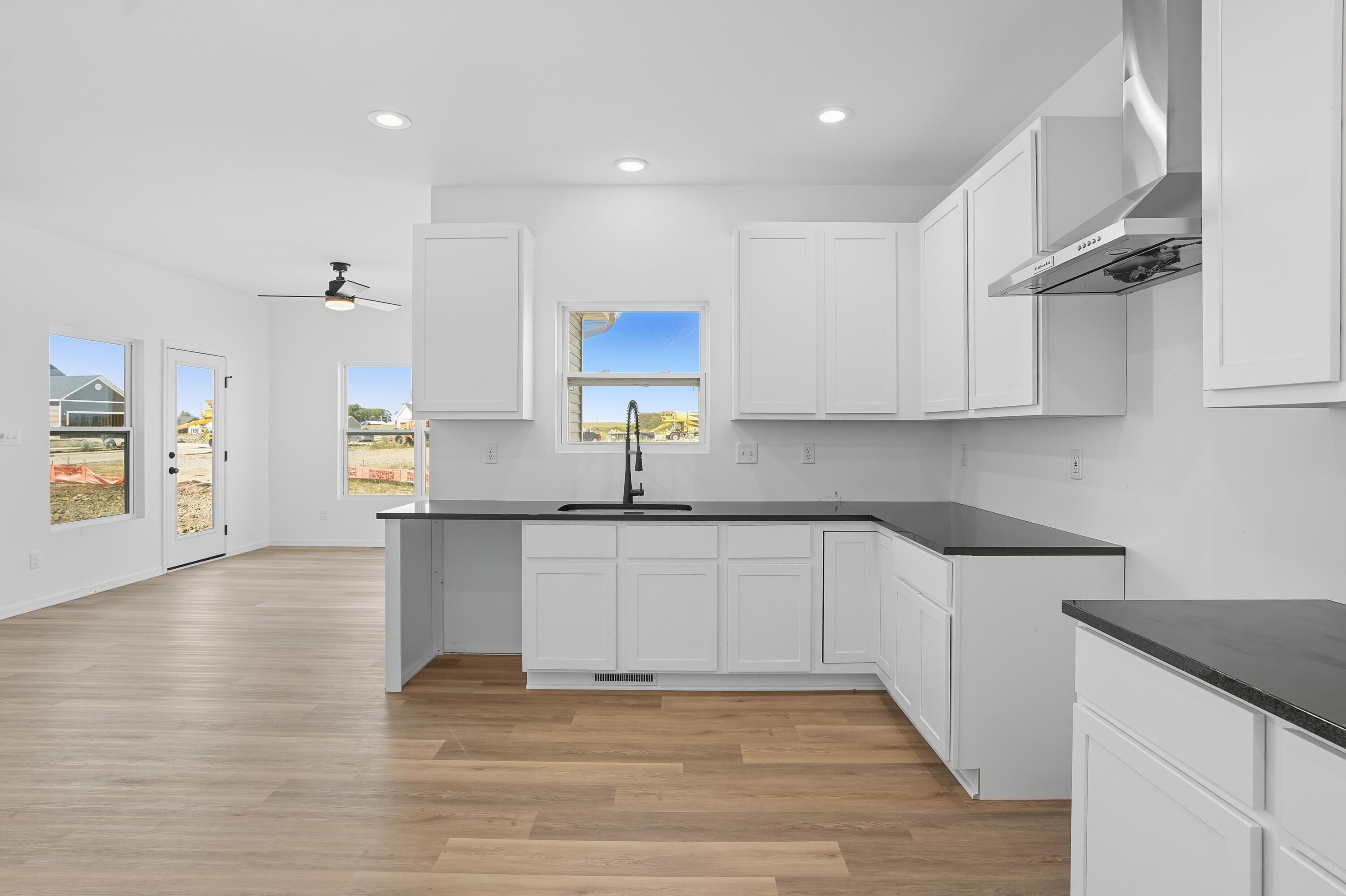 5800 Buck Lane Portage, IN 46368 - Photo 7 of 22 a kitchen with stainless steel appliances granite countertop a sink and cabinets