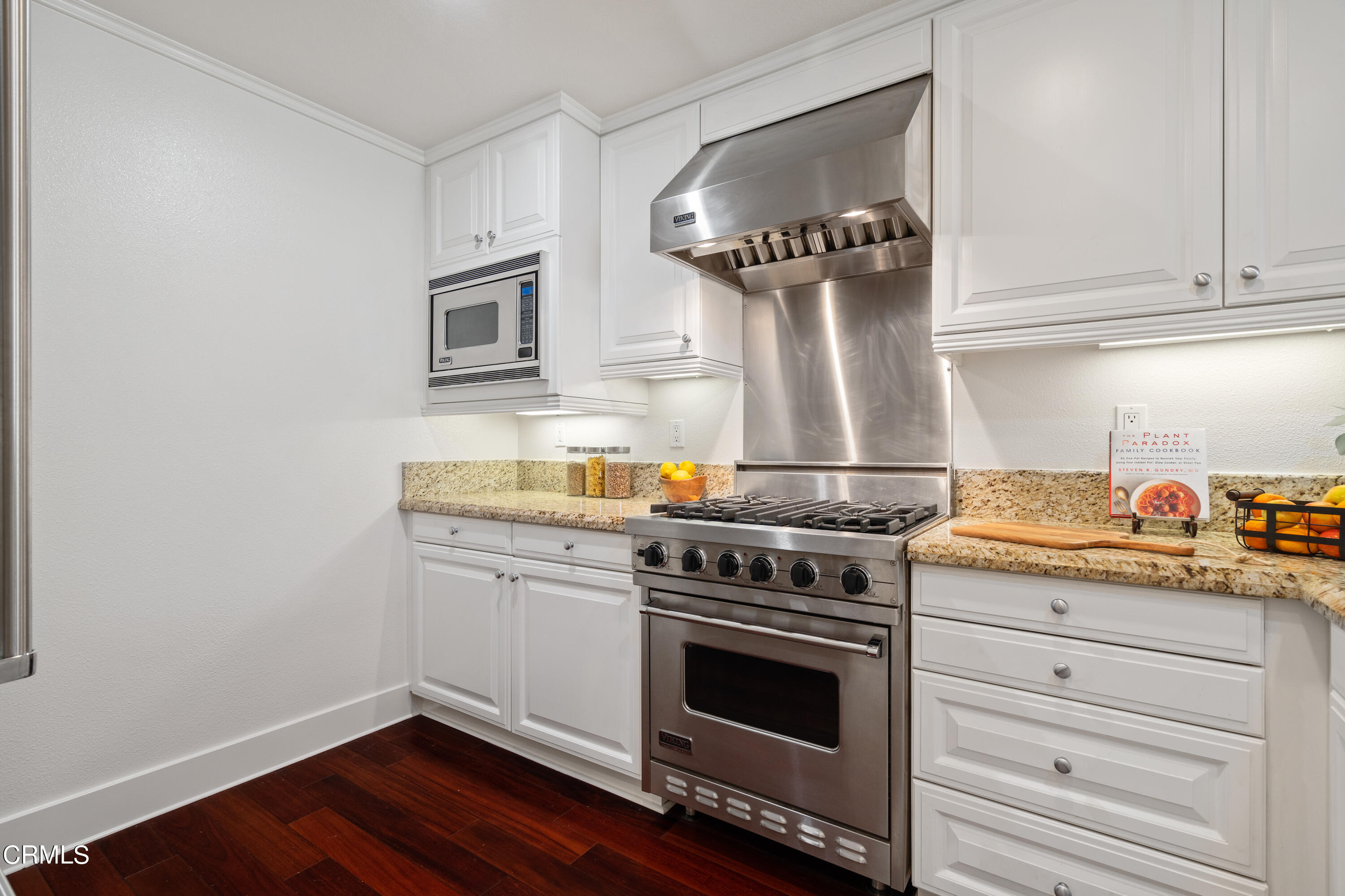 453 North Altadena Drive, Unit 5 Pasadena, CA 91107 - Photo 19 of 36 a kitchen with granite countertop a stove and a wooden floor
