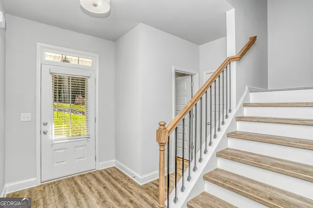 a view of an entryway with wooden floor