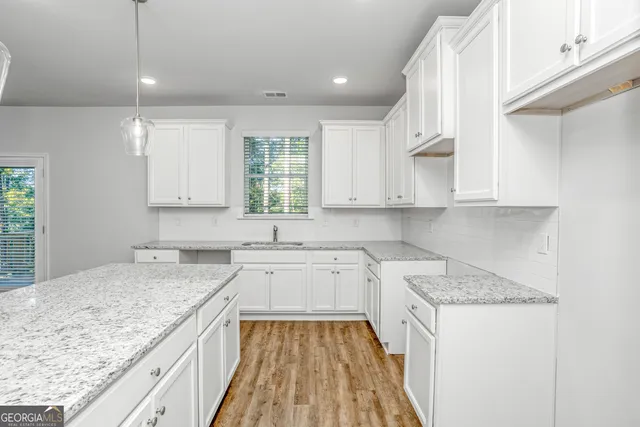 a kitchen with a sink stove and cabinets