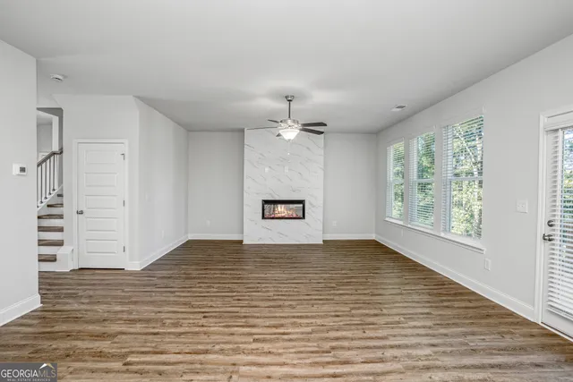 wooden floor in an empty room with a window